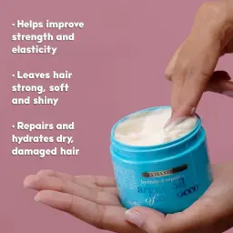 OGX Argan Oil of Morocco Hair Mask open in hand showing the cream texture