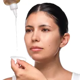 Applying The Ordinary Glycolic Acid 7% toner with a cotton pad